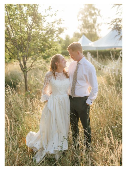 A couple in a meadow at golden hour